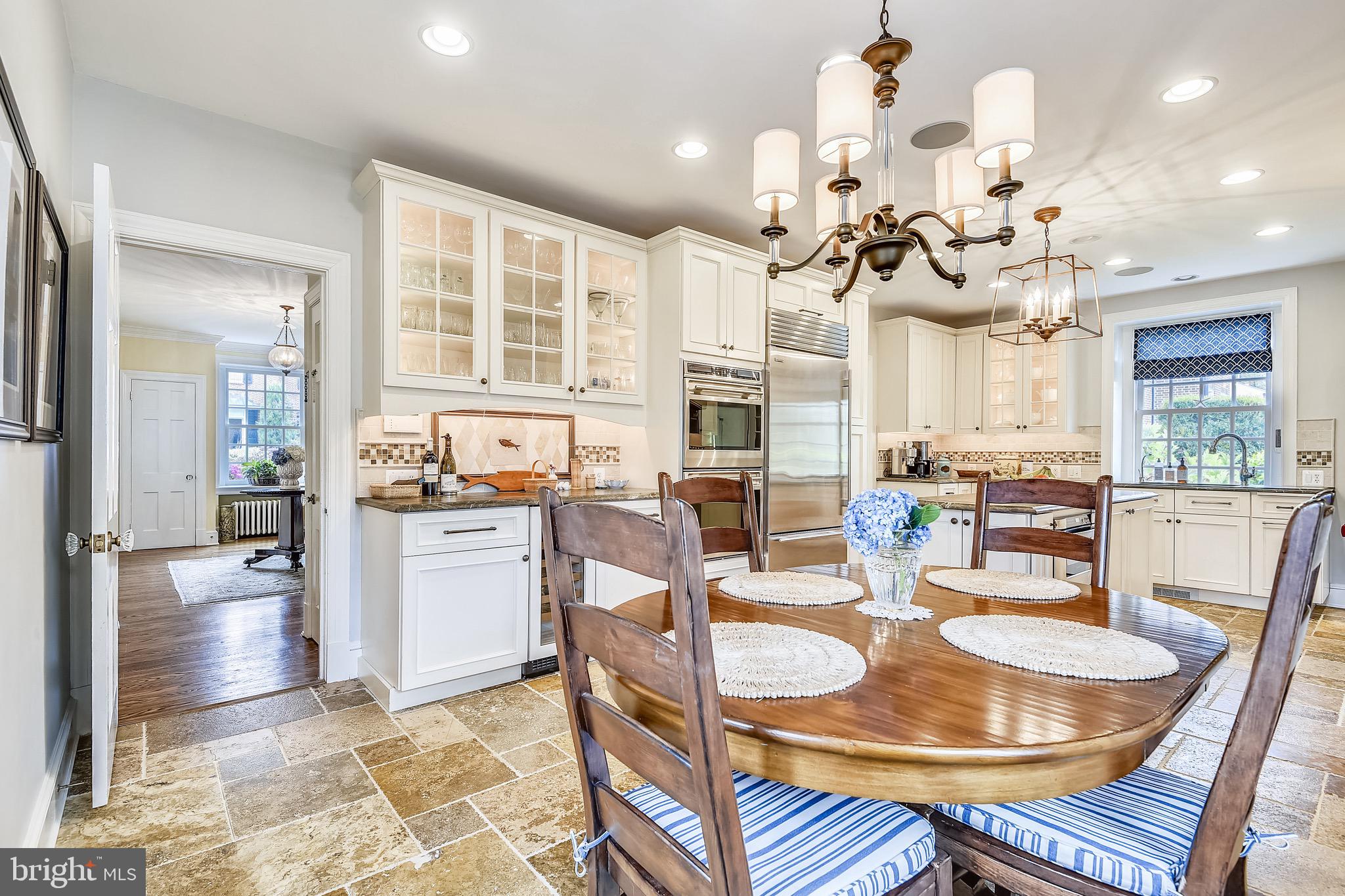 105 Tunbridge Road Baltimore, MD 21212 - Photo 17 of 62 a dining room with chandelier fan and wooden furniture