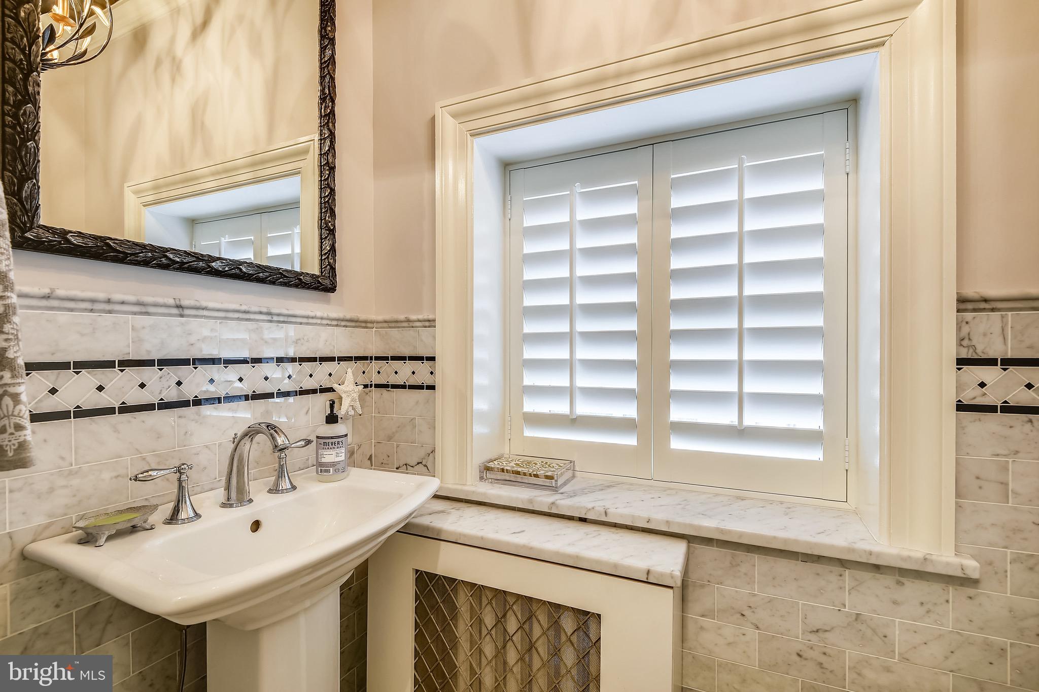 105 Tunbridge Road Baltimore, MD 21212 - Photo 21 of 62 a bathroom with a sink and a mirror