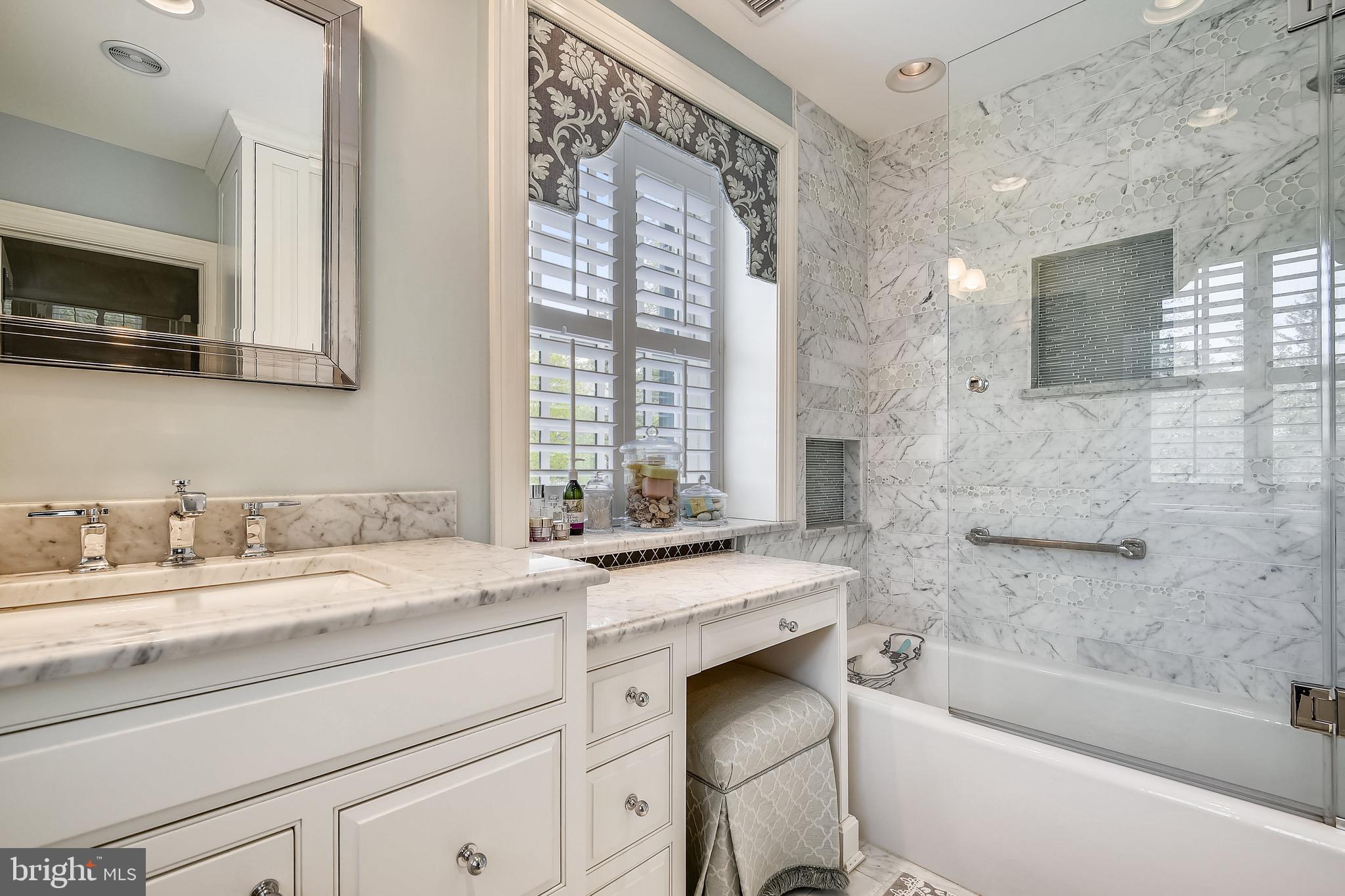 105 Tunbridge Road Baltimore, MD 21212 - Photo 29 of 62 a bathroom with a granite countertop sink a large mirror a bathtub and next to a window