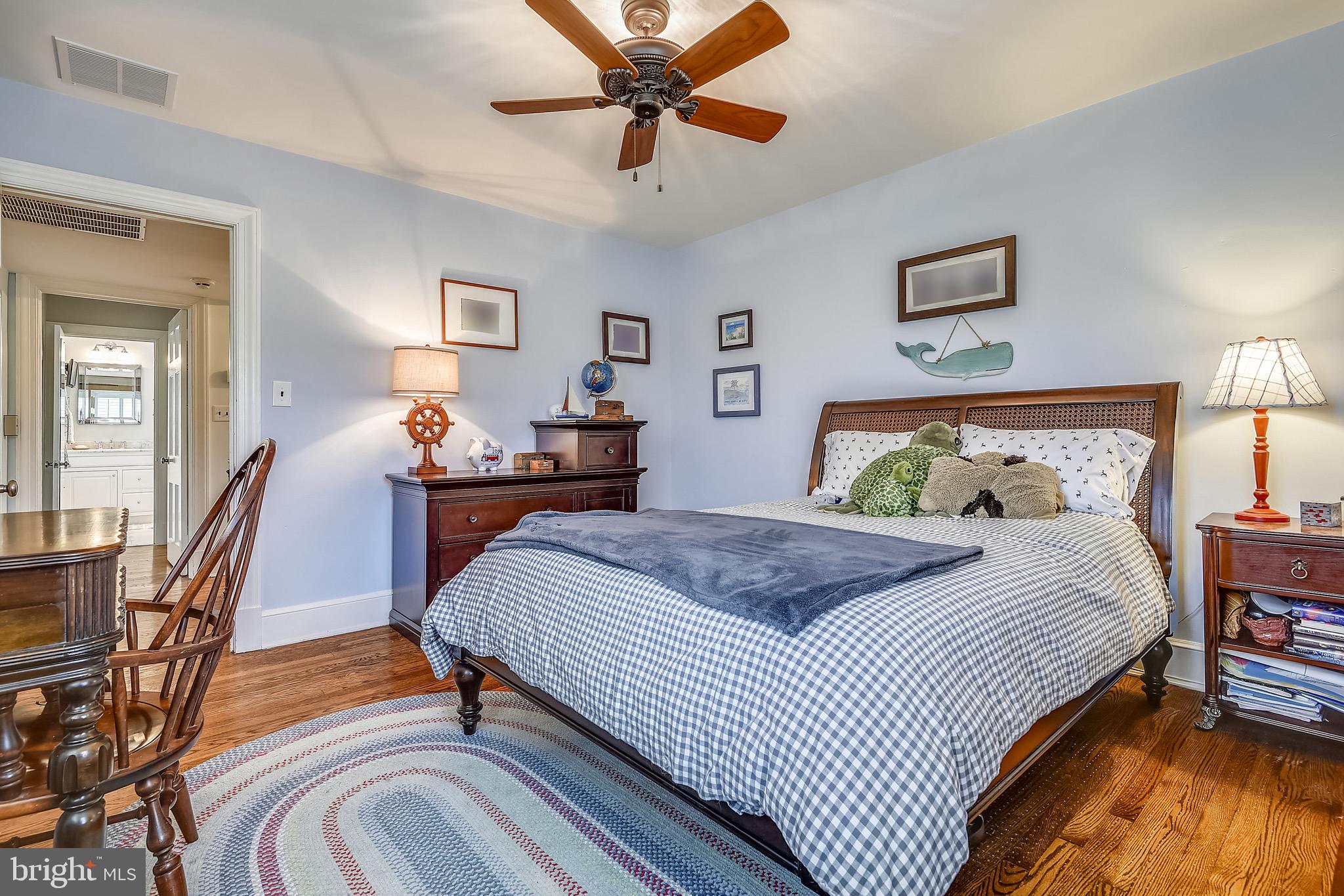 105 Tunbridge Road Baltimore, MD 21212 - Photo 31 of 62 a bedroom with a bed and wooden floor