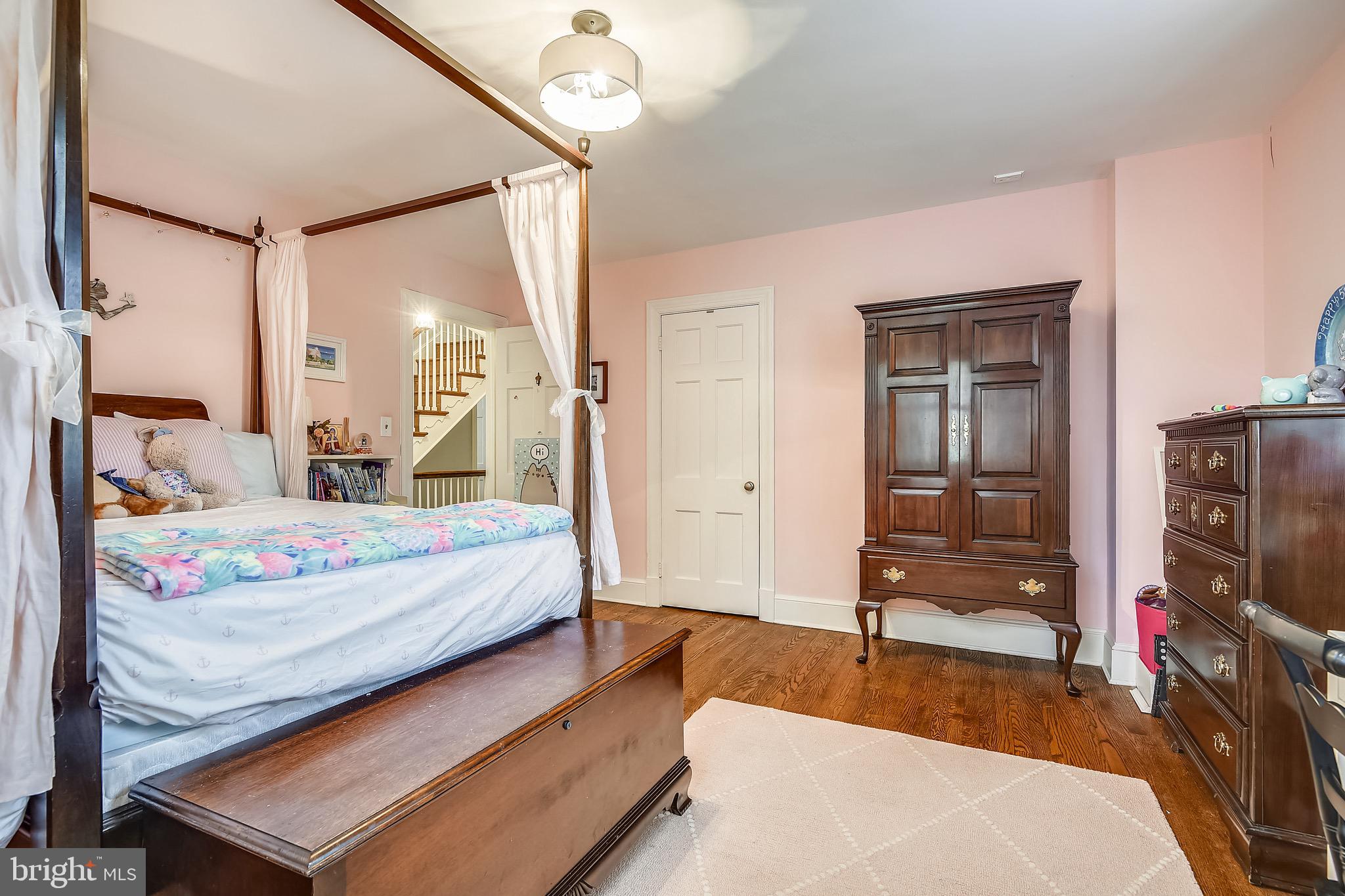 105 Tunbridge Road Baltimore, MD 21212 - Photo 33 of 62 a bedroom with a bed window and walk in closet with wooden floor