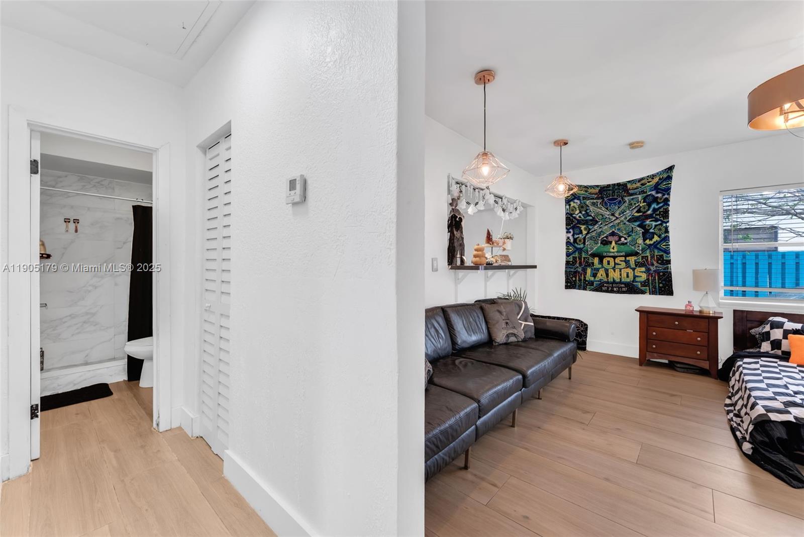 1105 Northeast 10th Street Hallandale Beach, FL 33009 - Photo 11 of 28 a living room with furniture and a chandelier