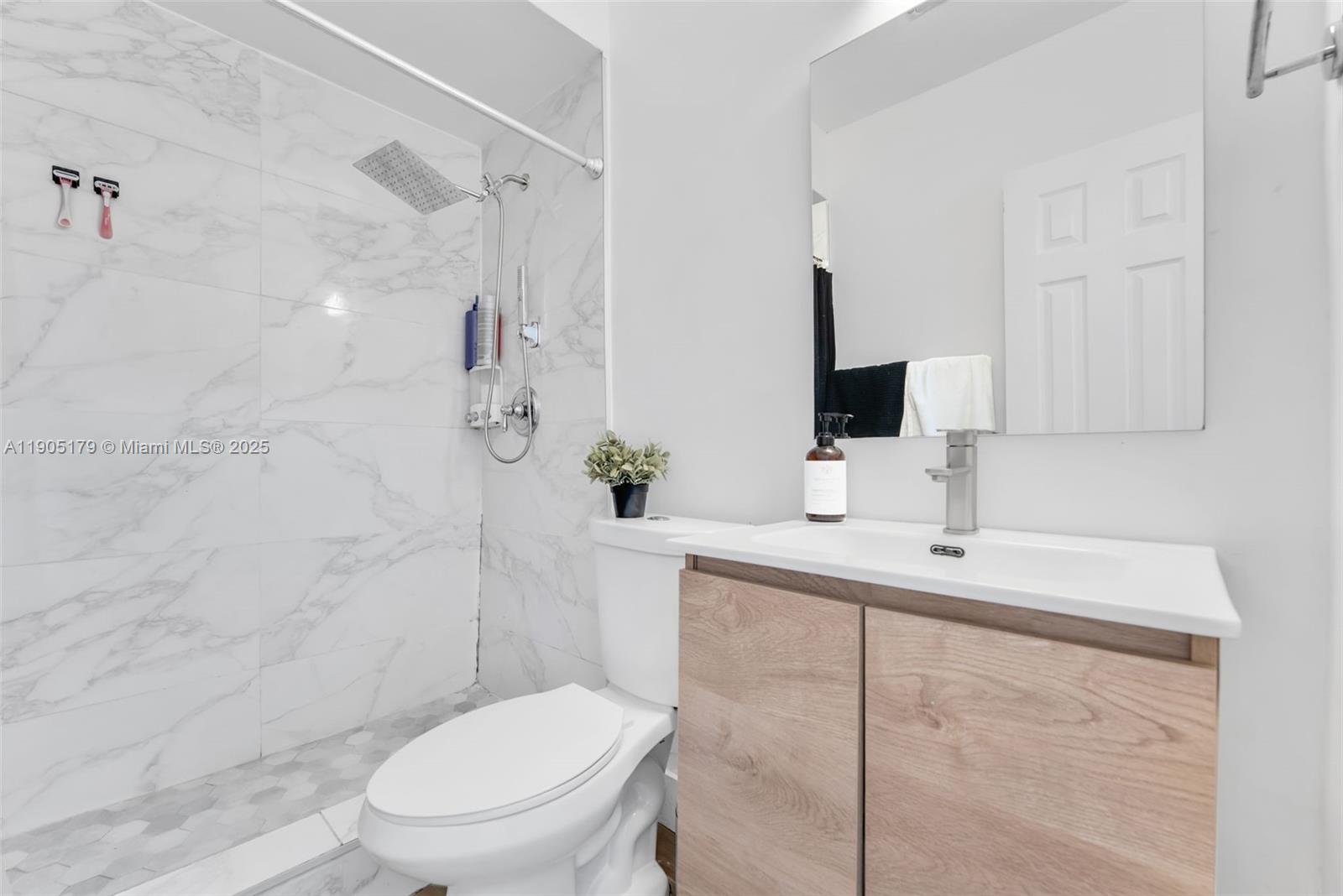 1105 Northeast 10th Street Hallandale Beach, FL 33009 - Photo 12 of 28 a bathroom with a sink toilet and shower