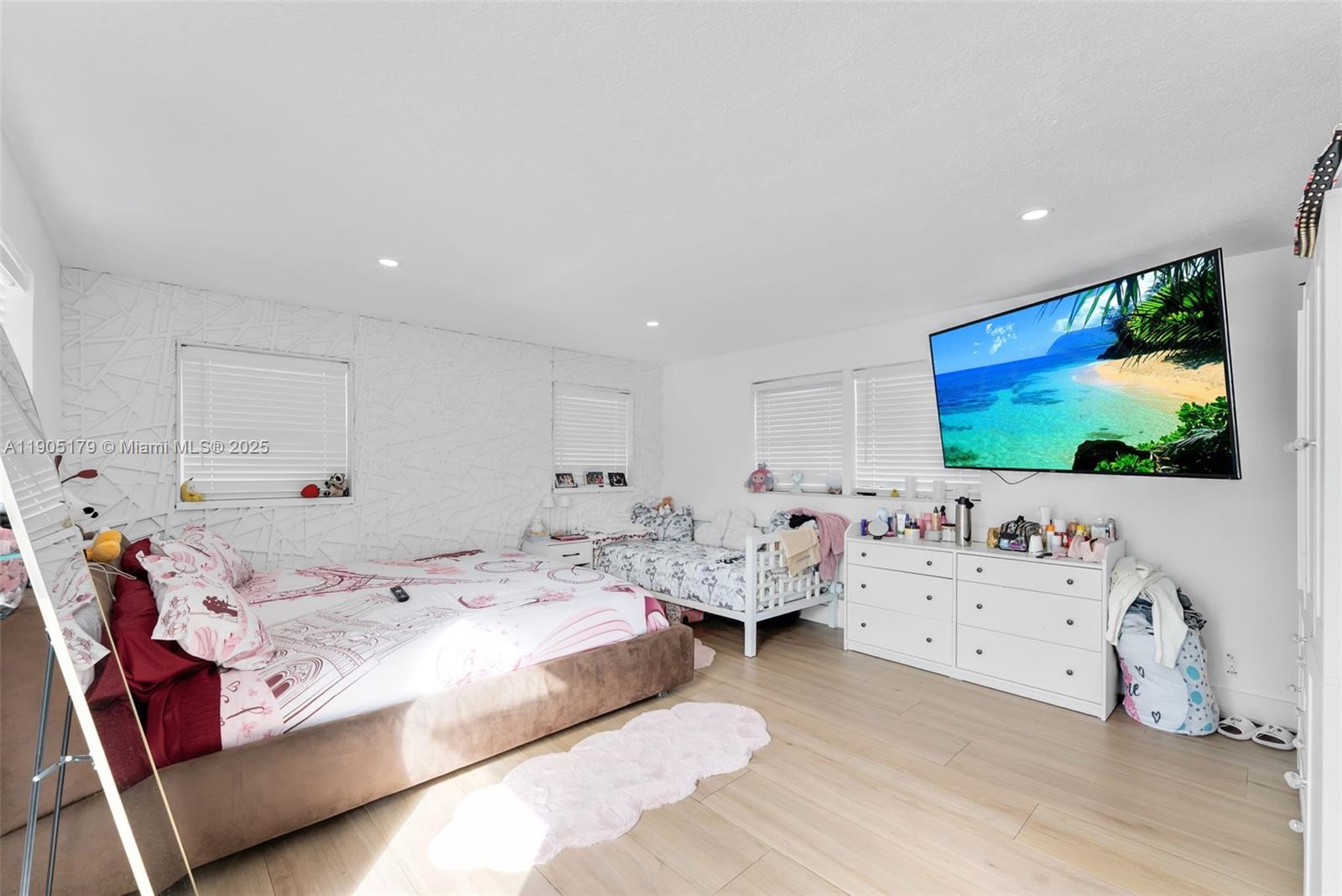 1105 Northeast 10th Street Hallandale Beach, FL 33009 - Photo 14 of 28 a bed room with furniture and flat screen tv