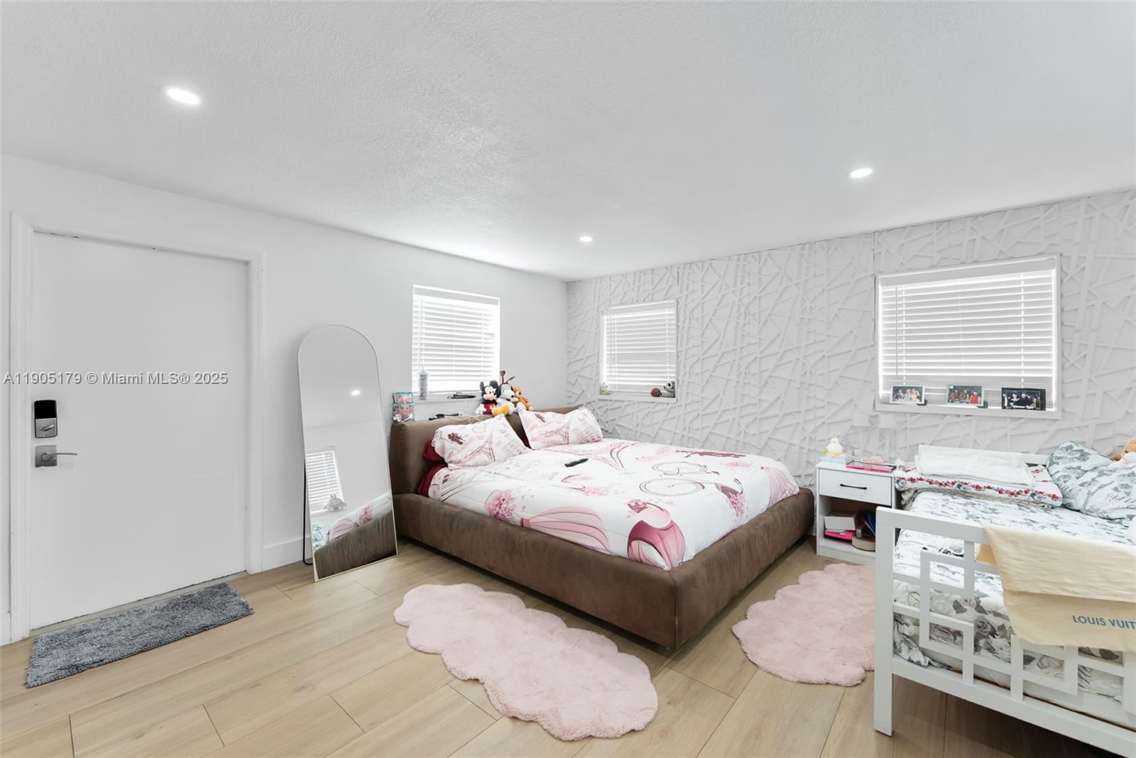 1105 Northeast 10th Street Hallandale Beach, FL 33009 - Photo 15 of 28 a spacious bedroom with a bed and a window