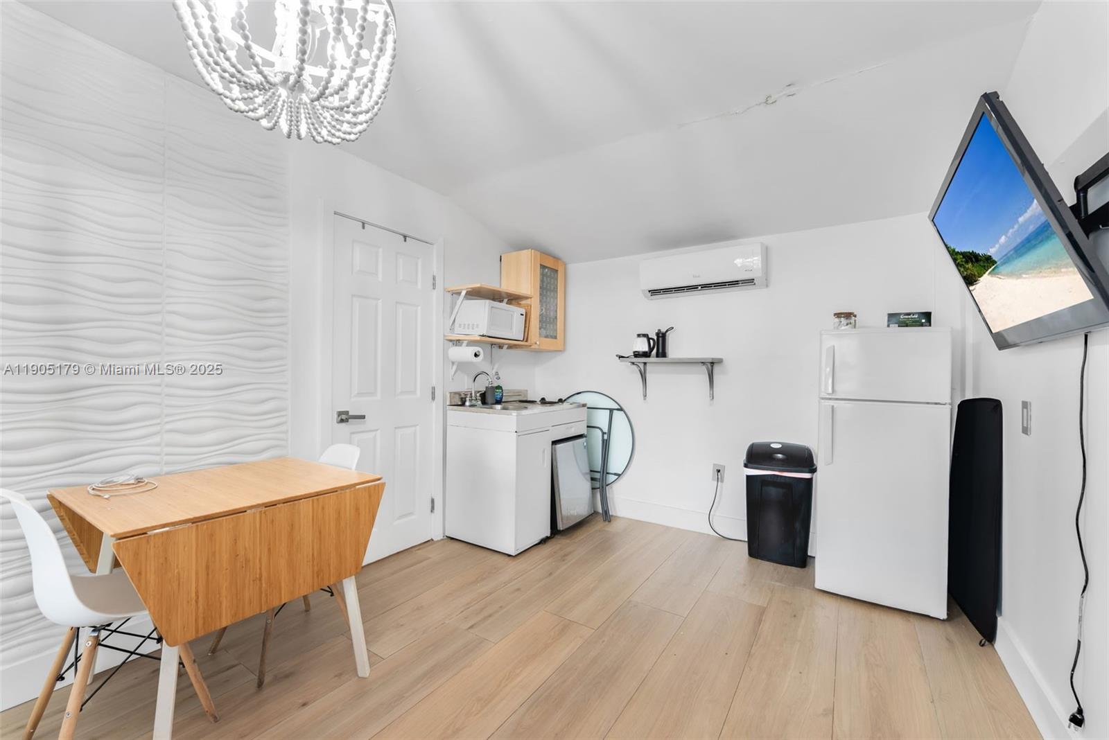 1105 Northeast 10th Street Hallandale Beach, FL 33009 - Photo 20 of 28 a view of a dining room with furniture and wooden floor