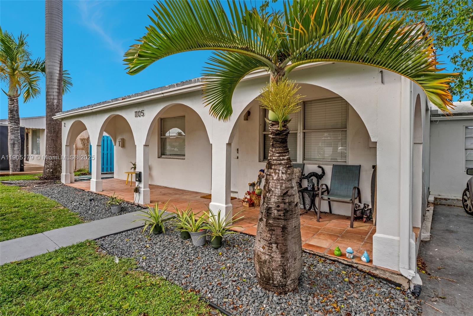 1105 Northeast 10th Street Hallandale Beach, FL 33009 - Photo 2 of 28 a front view of a house with garden