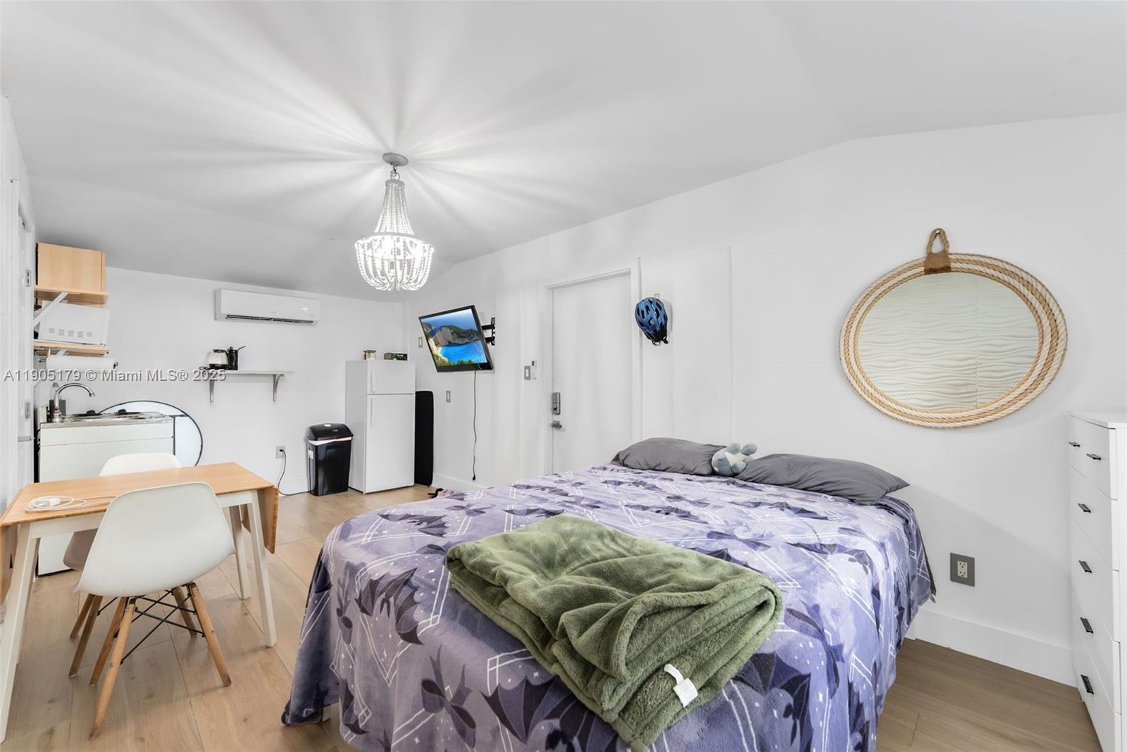 1105 Northeast 10th Street Hallandale Beach, FL 33009 - Photo 22 of 28 a bedroom with a bed and a chandelier