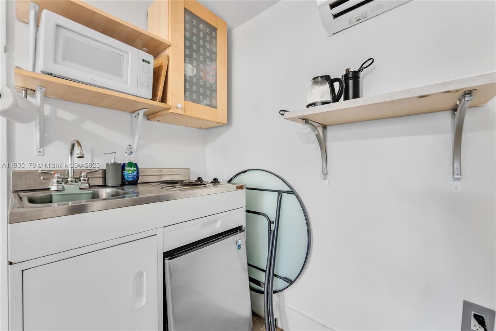 1105 Northeast 10th Street Hallandale Beach, FL 33009 - Photo 23 of 28 a kitchen with a sink and cabinets
