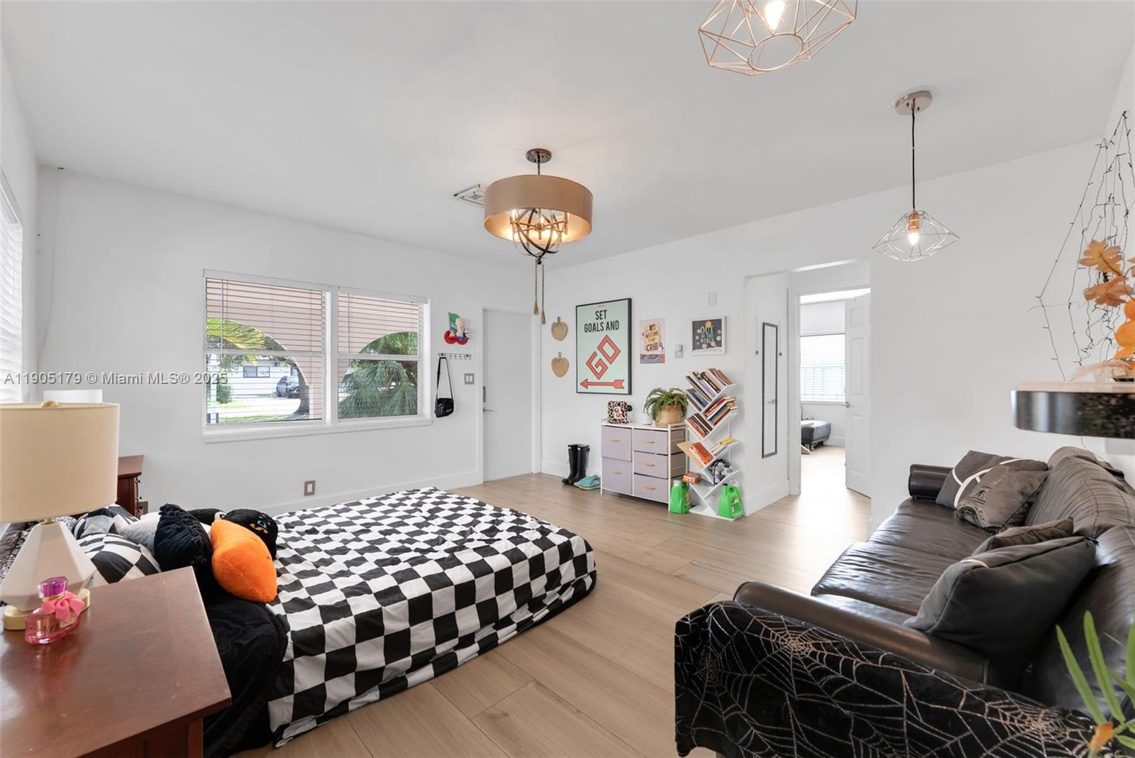 1105 Northeast 10th Street Hallandale Beach, FL 33009 - Photo 6 of 28 a bedroom with furniture and a chandelier