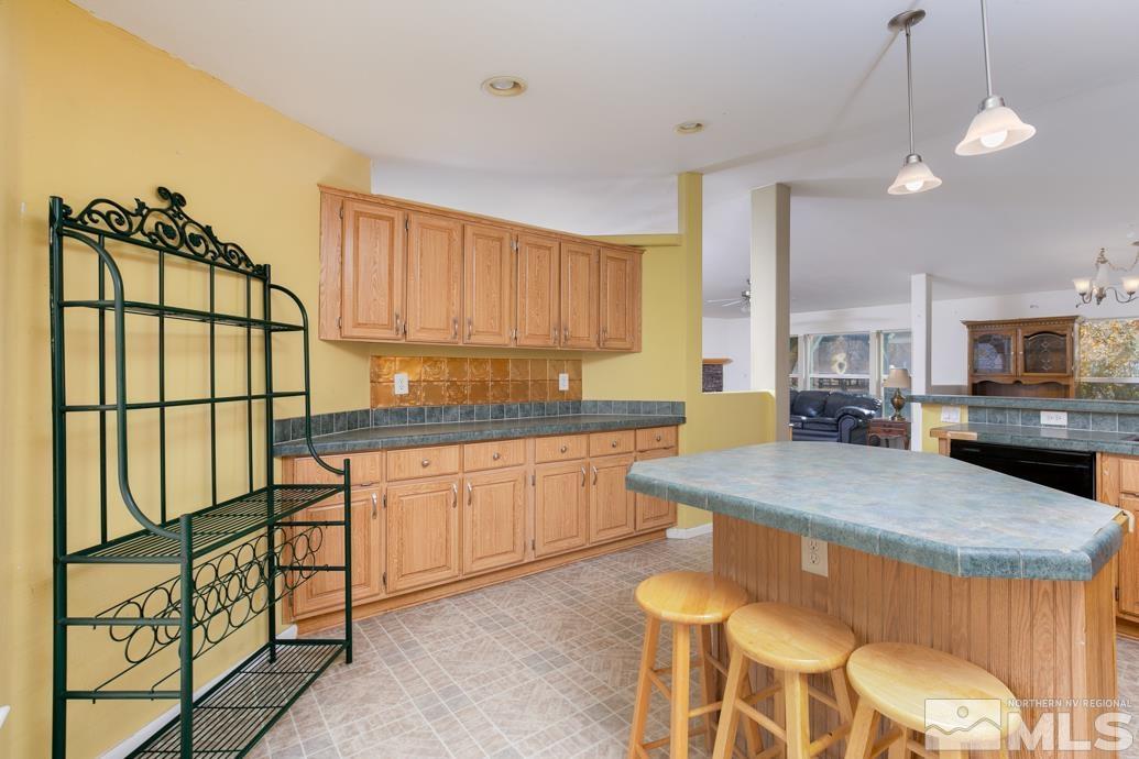 5605 Alcorn Road Fallon, NV 89406 - Photo 8 of 35 a kitchen with stainless steel appliances granite countertop wooden cabinets a sink and a stove