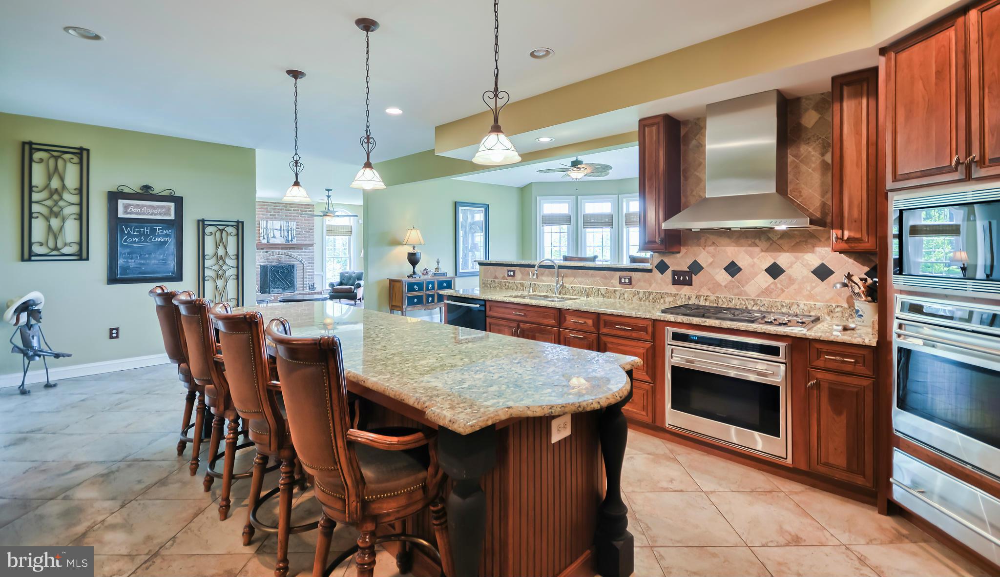 4522 Coxey Brown Road Myersville, MD 21773 - Photo 11 of 30 a kitchen with stainless steel appliances granite countertop a stove a refrigerator a oven a sink with a dining table and chairs