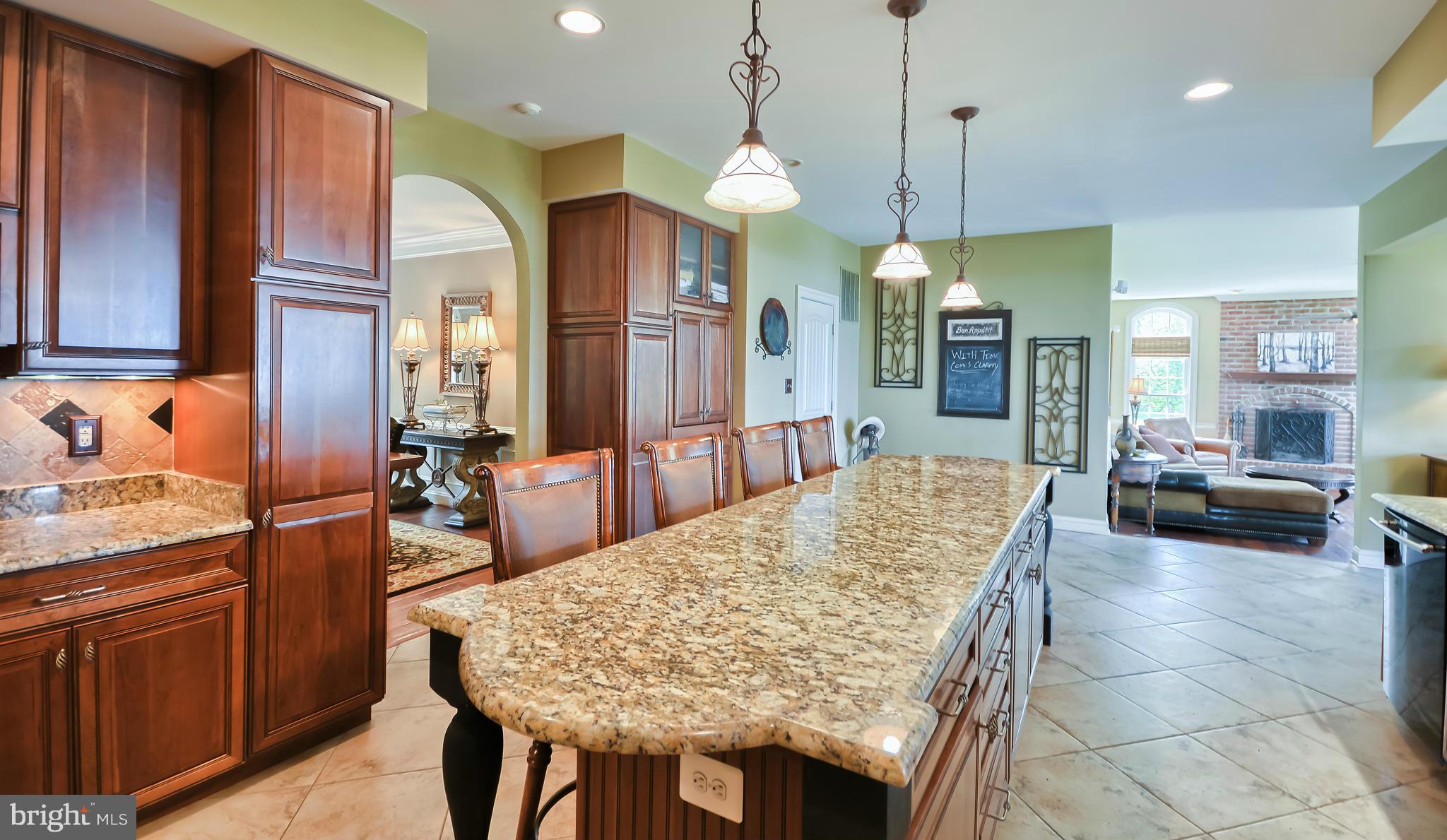 4522 Coxey Brown Road Myersville, MD 21773 - Photo 12 of 30 a large kitchen with kitchen island a chandelier a stove a sink a counter space and living room view