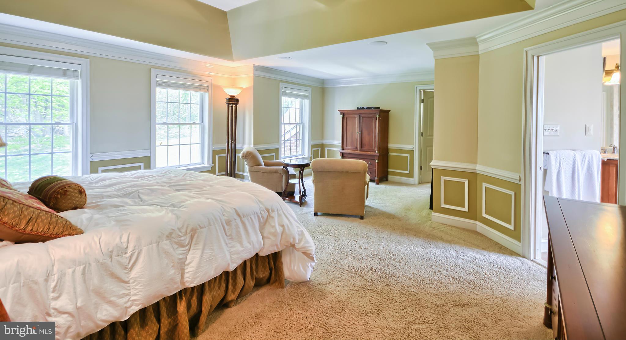 4522 Coxey Brown Road Myersville, MD 21773 - Photo 18 of 30 a spacious bedroom with a bed a table and large windows