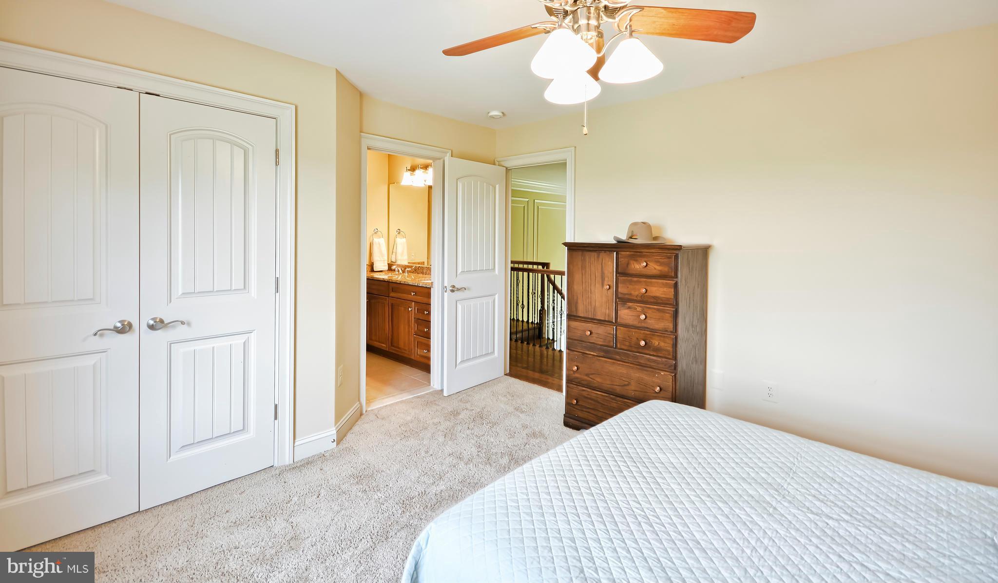 4522 Coxey Brown Road Myersville, MD 21773 - Photo 23 of 30 a bedroom with a bed and a chandelier