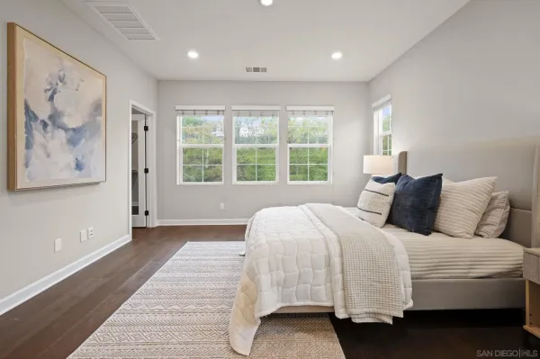 a bedroom with a large bed and a large window