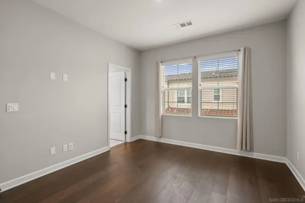 a view of wooden floor and windows in a room
