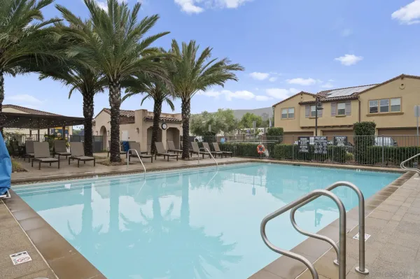 a swimming pool with outdoor seating and yard