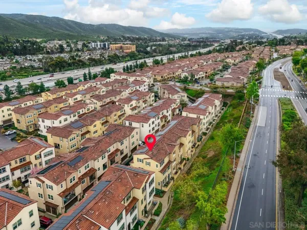 an aerial view of residential houses with outdoor space