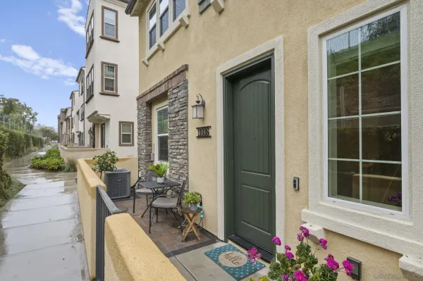 a view of a house with a chairs and table in a patio
