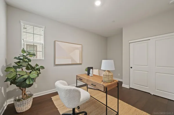 a dining room with furniture and a potted plant