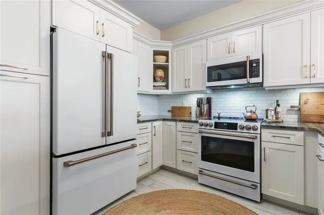 a spacious bedroom with a bed and a chandelier