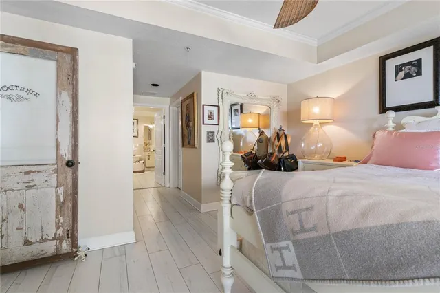 a bedroom with a large bed and a chandelier