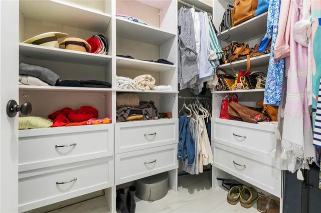 a bedroom with a bed flat screen tv and couches