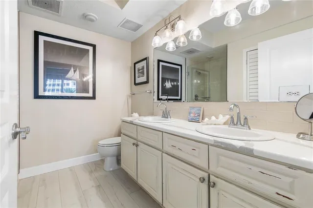 a front view of a house with a garden and trees