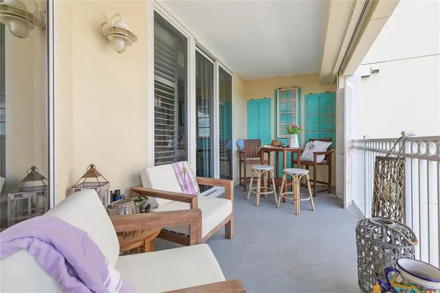 a very nice looking dining room with kitchen island a table and a chandelier
