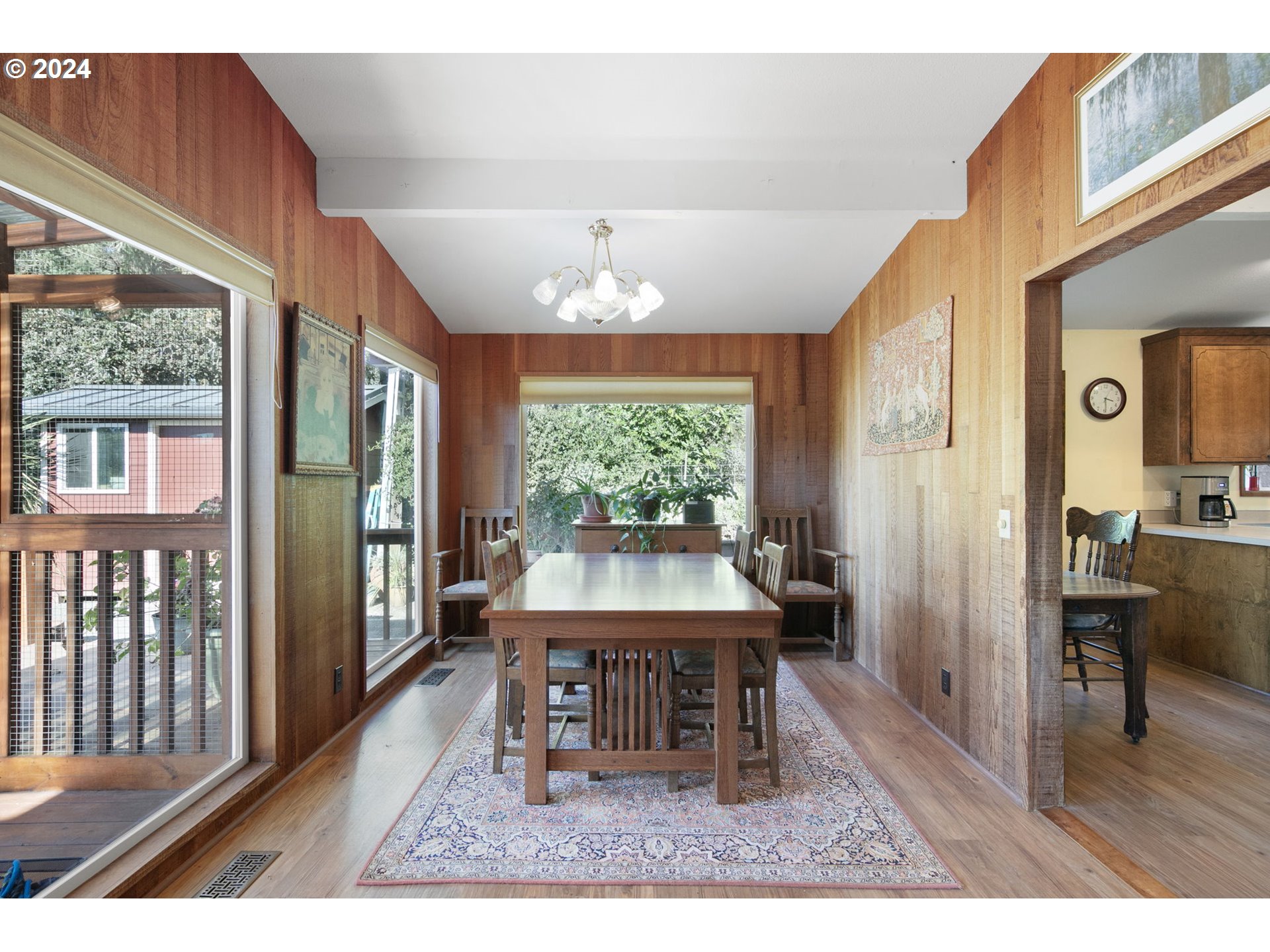 37797 Worth Road Springfield, OR 97478 - Photo 15 of 47 a dining room with wooden floor a chandelier a wooden table and chairs