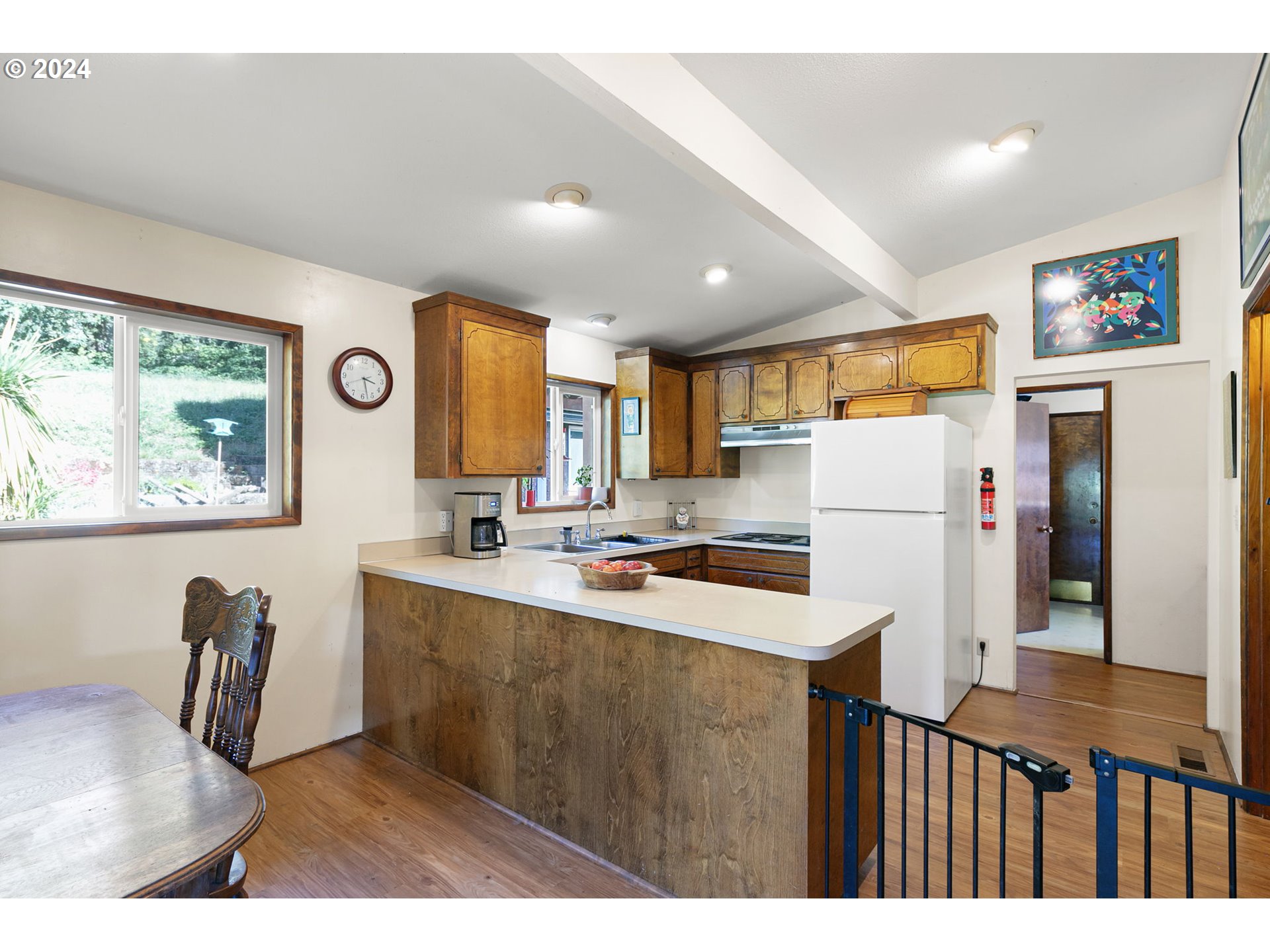 37797 Worth Road Springfield, OR 97478 - Photo 20 of 47 a kitchen with stainless steel appliances a refrigerator a sink a stove a dining table and chairs