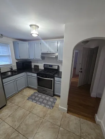a kitchen with a stove a sink and a refrigerator