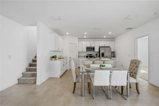 a dining room with furniture and window