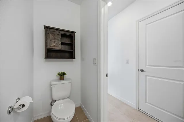 a view of a hallway with wooden floor and a potted plant