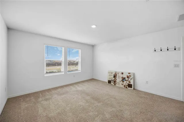 a spacious bathroom with a shower a sink and a mirror