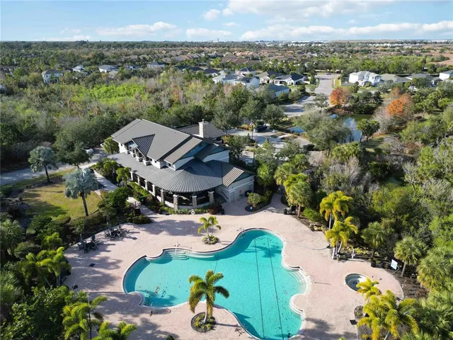 an aerial view of a house with a yard