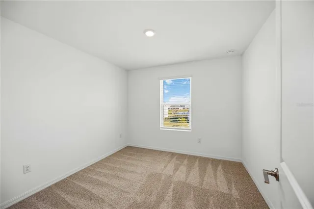 a view of a big house with wooden fence