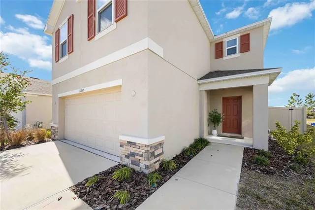a front view of a house with garden
