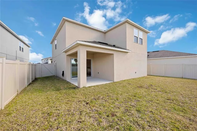 a living room with furniture and view of kitchen