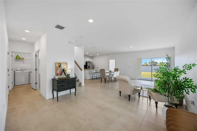 a living room with furniture and a potted plant