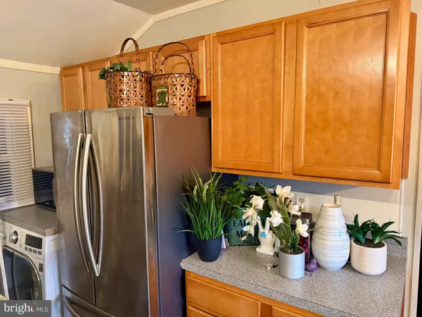 a kitchen with a refrigerator and a white cabinets