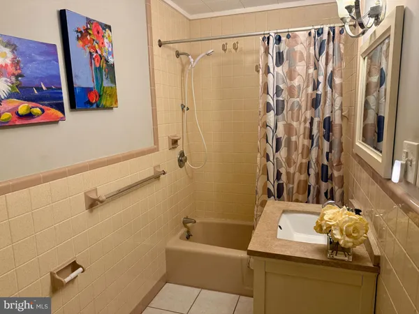 a bathroom with a sink and a shower curtain