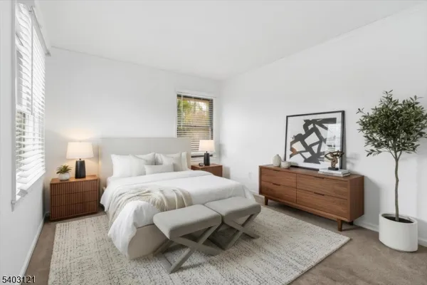 a bedroom with a bed and a potted plant