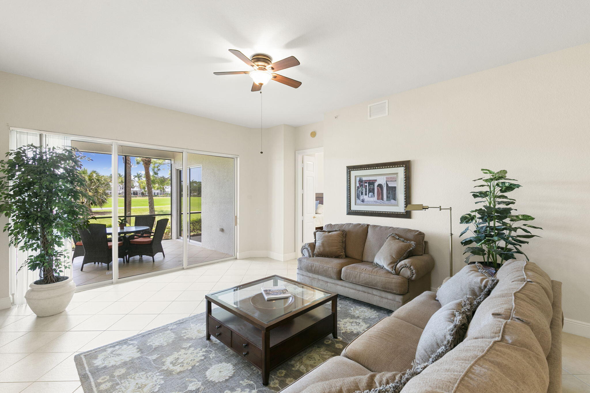 9066 Cascada Way, Unit 101 Naples, FL 34114 - Photo 7 of 51 a living room with furniture and a large window