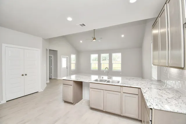 a kitchen with a sink stove and cabinets
