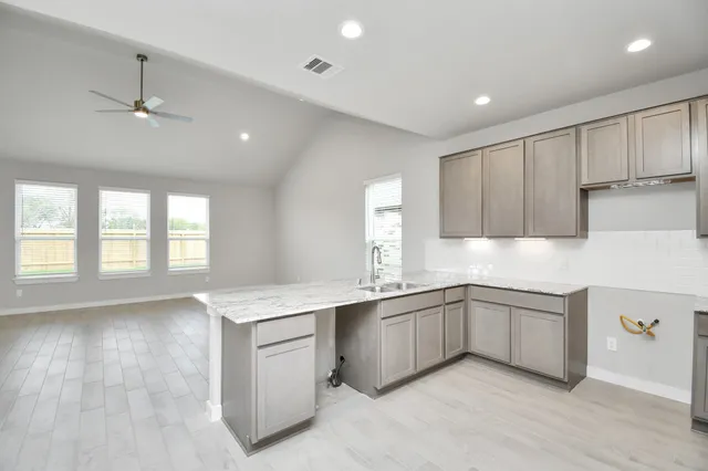 a view of kitchen with refrigerator and window