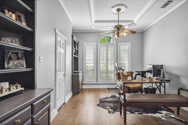 a dining room with wooden floor and a chandelier