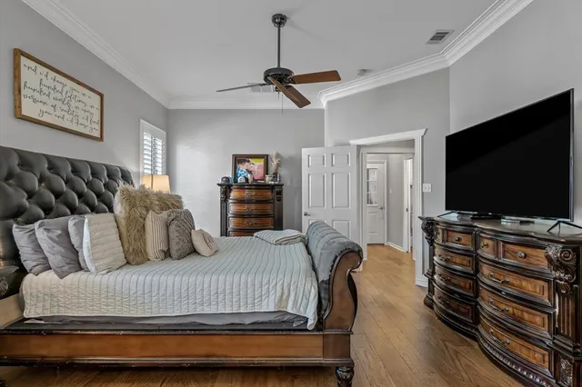 a bedroom with furniture and a flat screen tv