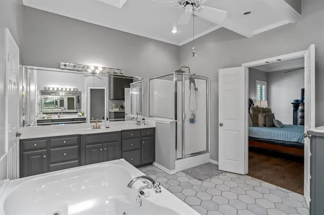 a spacious bathroom with a sink a vanity and shower
